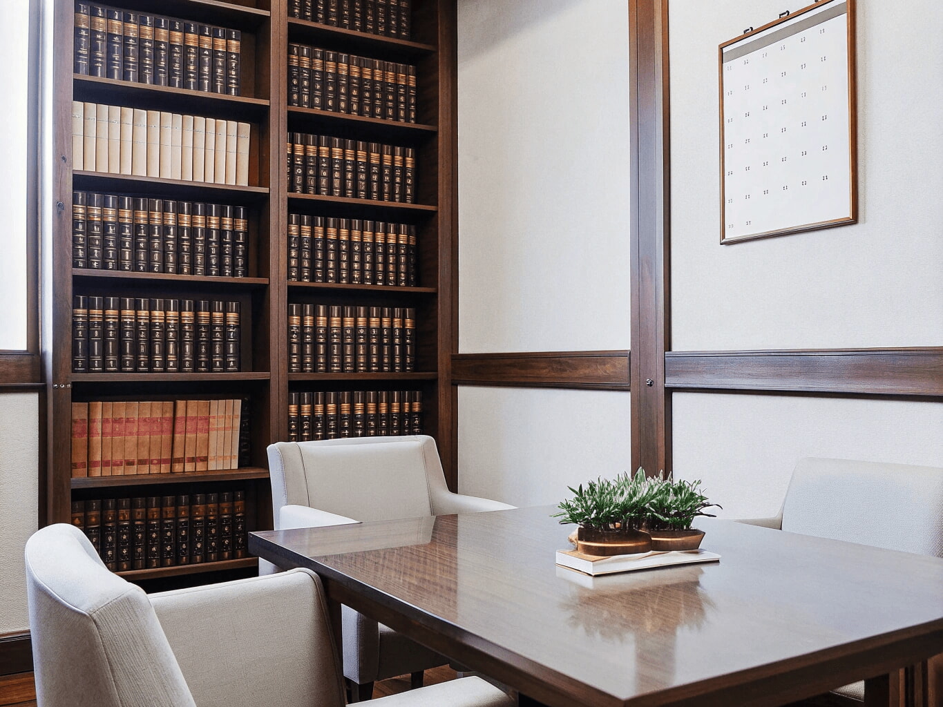 A small conference room with legal books on the shelves